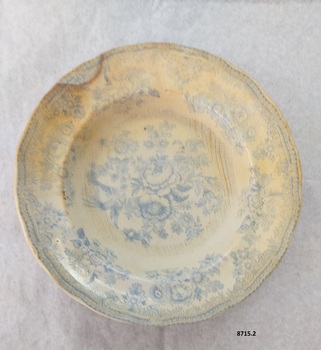 Dinner plate  with a blue floral design featuring two pheasants.