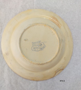 Bottom of cream dinner plate with blue maker's mark.
