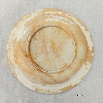Bottom of plate showing initial glazing and where it has worn off, plus the maker's stamp.