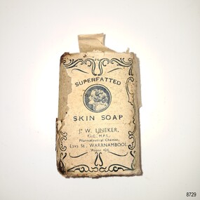 Cream wrapper with printed blue decoration and text. Image of a female within a boarder