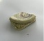 Fragment of china with partial manufacturer's stamp and raised curved edge.