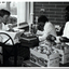 Three people making apple cider