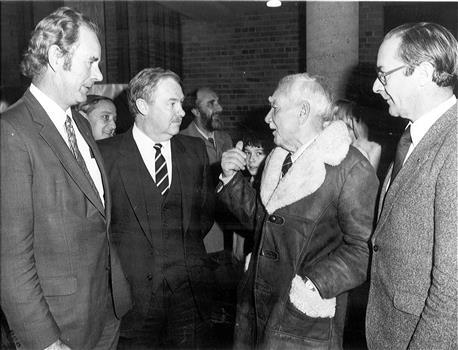 four men chatting in a group