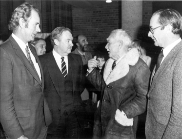 four men chatting in a group