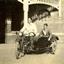 Two men on a motorbike with side car