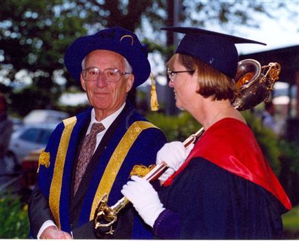 Chancellor David Caro and a mace bearer