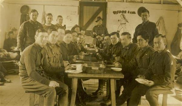 Australian soldiers sit around a table