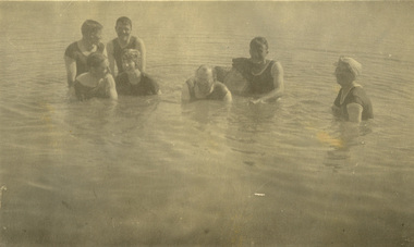 Eight people swimming