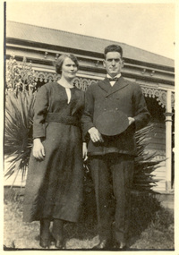 A man and a lady in front of a house