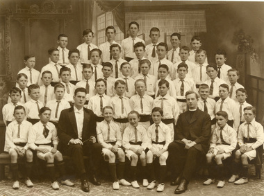 Choirboys with a priest and Frank Wright (conductor)
