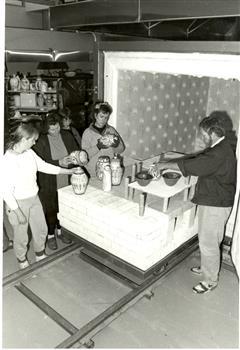 People standing around a kiln