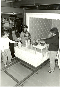 People standing around a kiln