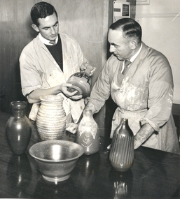 Two men with ceramic vessels