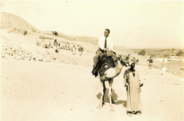 Photograph - Black and White, Frank Wright riding a camel, May 1940