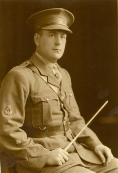 A man in uniforn holding a baton