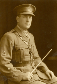 A man in uniforn holding a baton