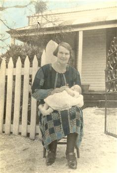 Seated woman holding a baby