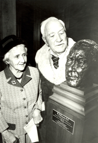 2 people look at a sculpture