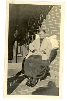 A woman sits on a chair
