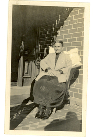 A woman sits on a chair