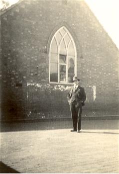 A man in front of a church