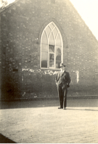 A man in front of a church