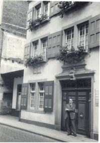 Photograph, Frank Wright standing outside  an ornate door