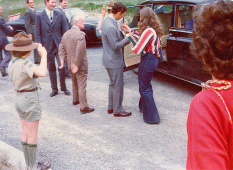 Prince Charles is presented with a flower before entering his car