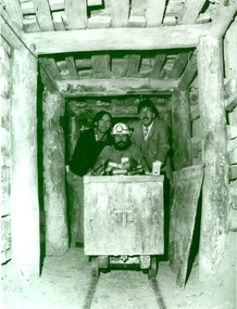 Photograph - Black and White, 1988, Three men standing behind a trolley in a mine tunnel, 06/1988
