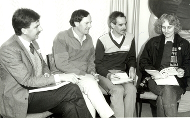 Photograph, Four people discussing the Ballarat School of Mines Access Publication