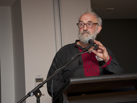 A man stands behind a microphone