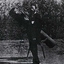 A man stands beside a telescope