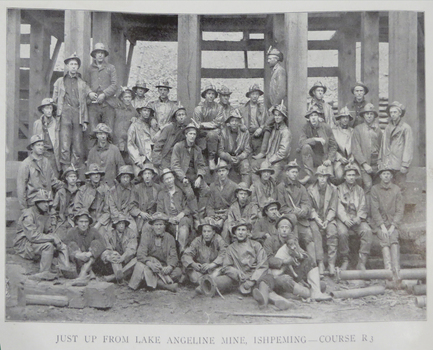 A number of men pose for a photograph outside a mine