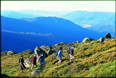 A group of people walking on a mountain