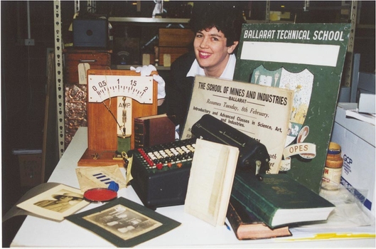 A woman surrounded by historical artefacts