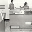 Two women and a large computer