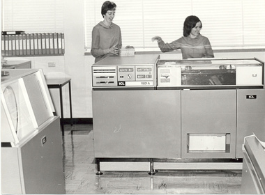 Two women and a large computer