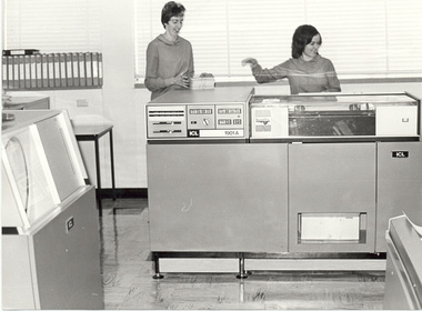 Two women and a large computer