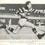 A footballer runs with a ball.