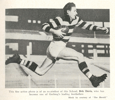 A footballer runs with a ball.