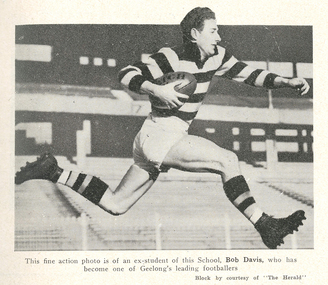A footballer runs with a ball.