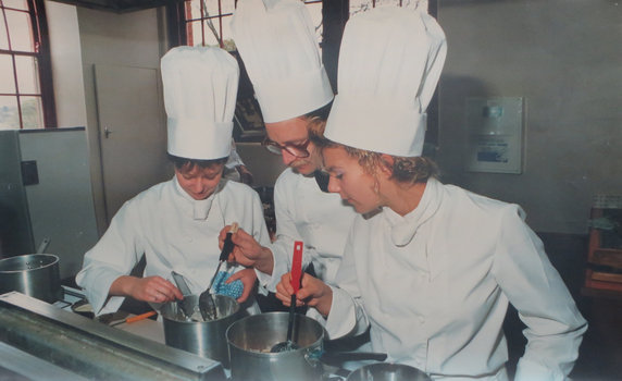 Three cooks in chefs hats