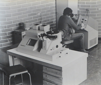 Photograph, Student using metallurgical electron microscope, 1974