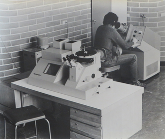 Photograph, Student using metallurgical electron microscope, 1974
