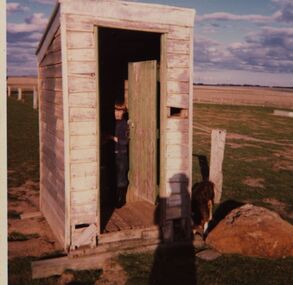 Photograph - Colour, Chatham-Holmes Collection: Andrew Chatham in the Out House, Kur-a-ruc South, Rokewood, Vic. {circa 1976)