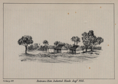 two huts surrounded by trees