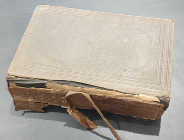 Front cove of book showing deteriorated spine