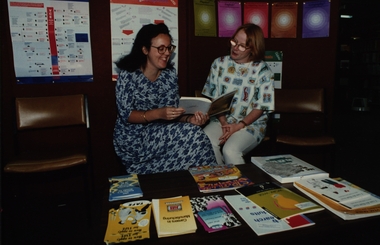 Photograph - Photograph - Colour, Ballarat Courier, Library Staff Co-ordinator Kirsten Martin and Library Officer Tania Gaunt in library looking at course brochures, 29/01/1994