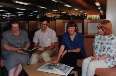 Photograph - Photograph - Colour, SMB staff looking at books in the SMB Library