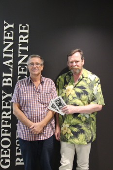 Two men holding bookplates